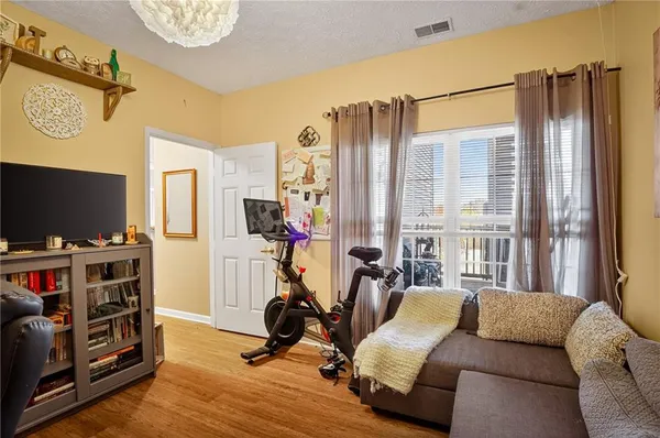 a view of a livingroom with workspace and a window