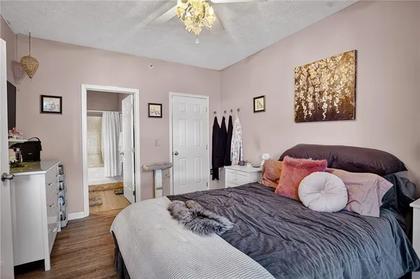 a bedroom with a large bed and a chandelier