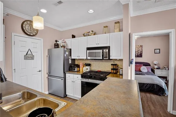 a kitchen with a refrigerator and a stove top oven