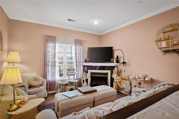 a living room with furniture a flat screen tv and a fireplace