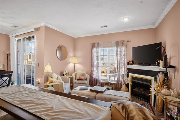 a living room with fireplace furniture and a flat screen tv