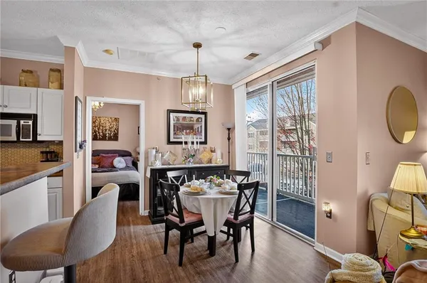 a view of a dining room with furniture window and wooden floor