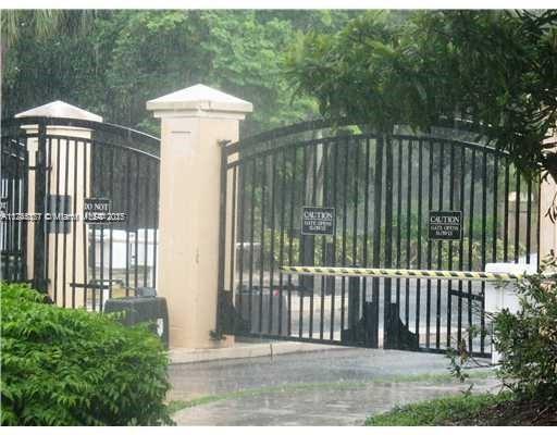 a view of a house with a floor to ceiling window and wooden fence