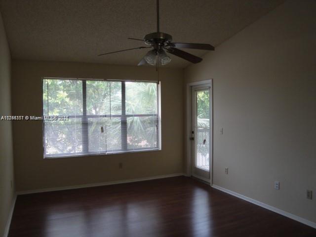 Palm Aire Gardens Condominiums Pompano Beach, FL 33069 - Photo 7 of 14 an empty room with wooden floor and windows