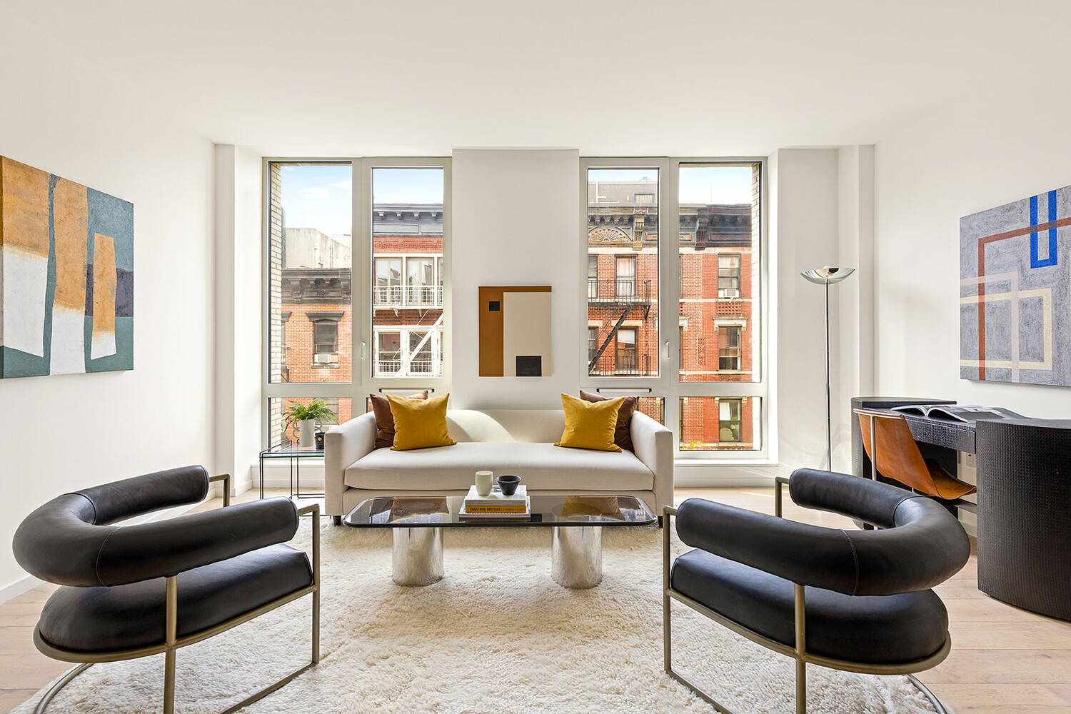 a living room with furniture and a floor to ceiling window
