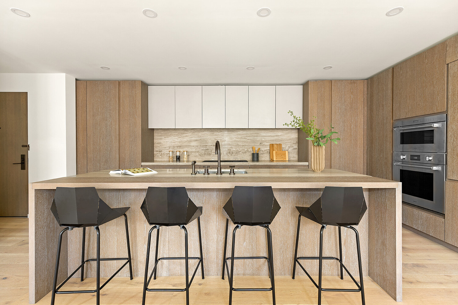 66 Clinton Street, Unit 5A Manhattan, NY 10002 - Photo 2 of 15 a kitchen with a center island a window and chairs