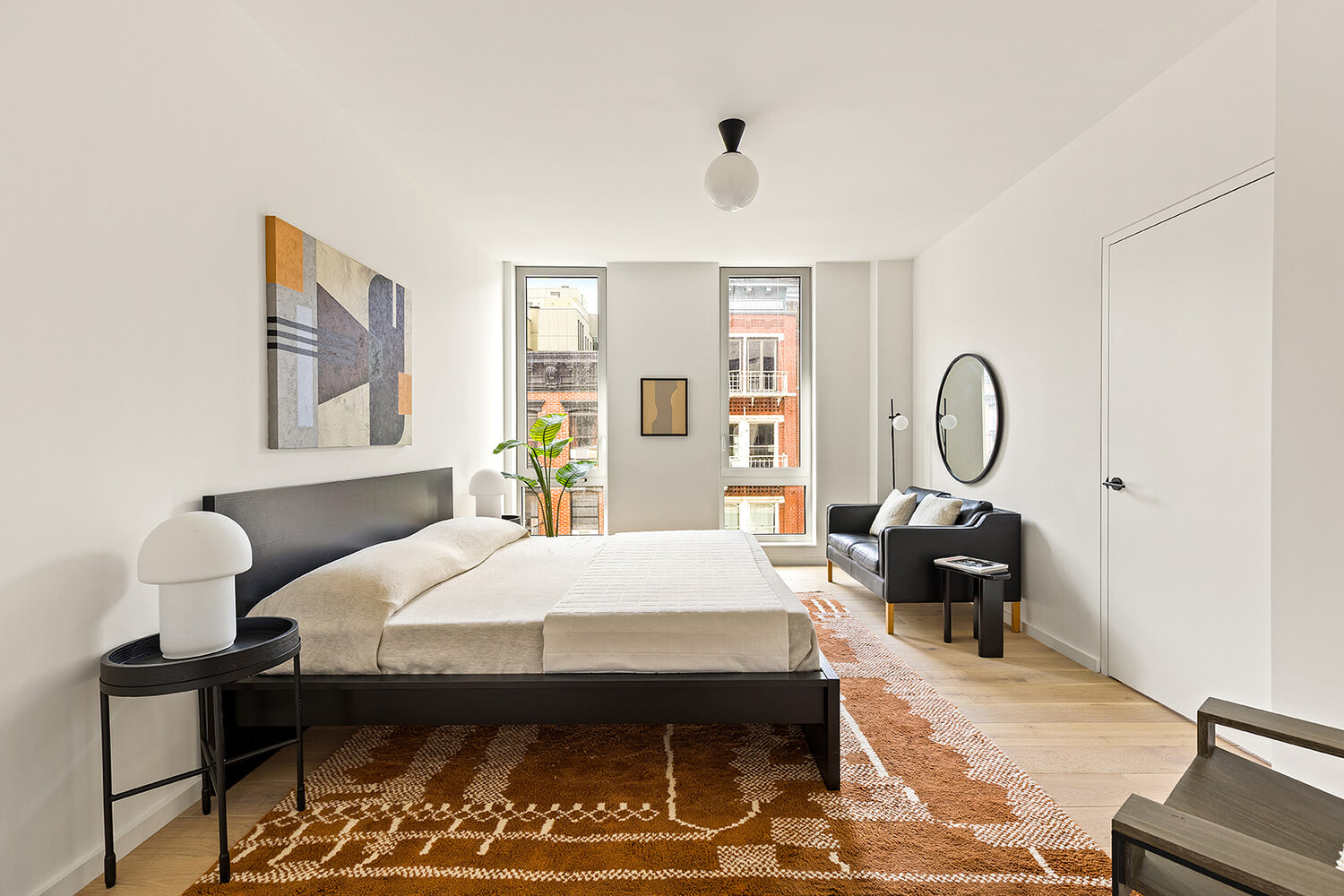 66 Clinton Street, Unit 5A Manhattan, NY 10002 - Photo 6 of 15 a bedroom with a bed and wooden floor