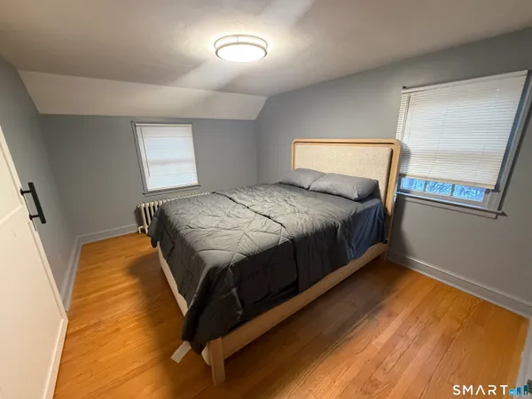 a bed sitting in a bedroom next to a window