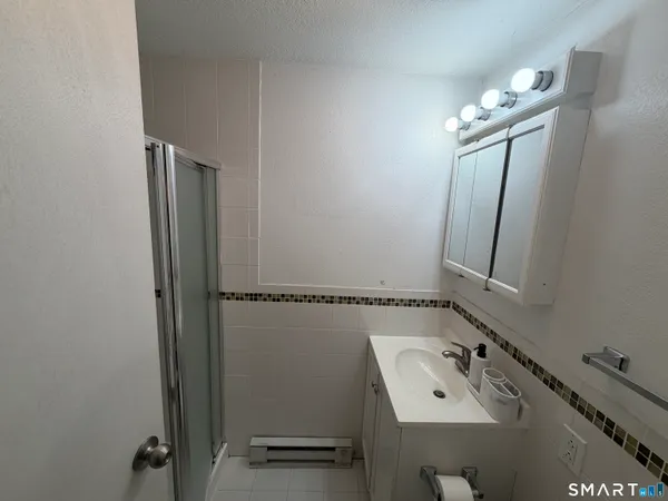 a bathroom with a sink vanity and mirror