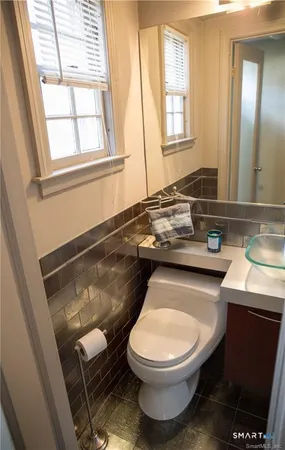 a bathroom with a toilet a sink and a window
