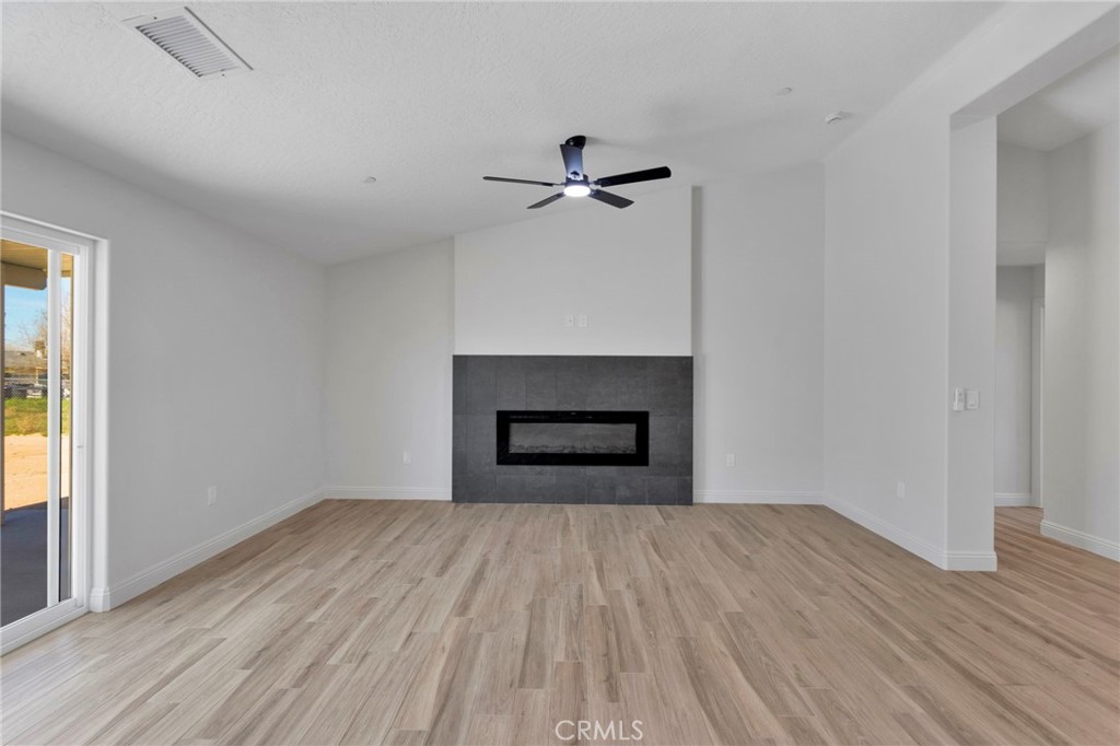 9432 Wasco Hesperia, CA 92345 - Photo 13 of 45 wooden floor fireplace and natural light in room