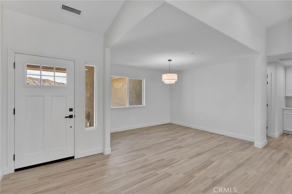 9432 Wasco Hesperia, CA 92345 - Photo 15 of 45 a view of an empty room with wooden floor and a window