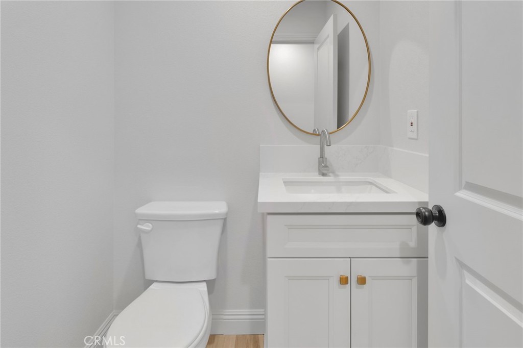 9432 Wasco Hesperia, CA 92345 - Photo 18 of 45 a bathroom with a toilet sink and mirror