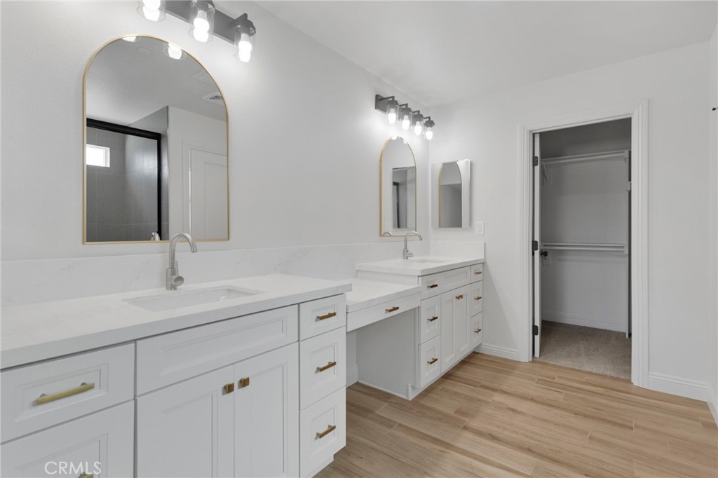 9432 Wasco Hesperia, CA 92345 - Photo 24 of 45 a bathroom with a double vanity sink and mirror