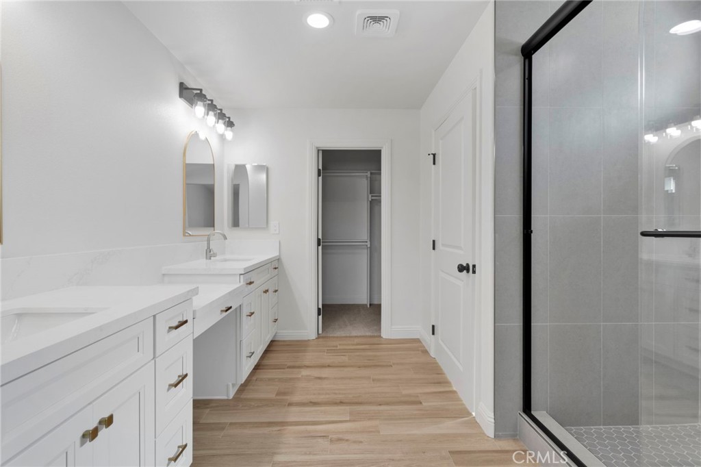 9432 Wasco Hesperia, CA 92345 - Photo 25 of 45 a spacious bathroom with a double vanity sink and a mirror