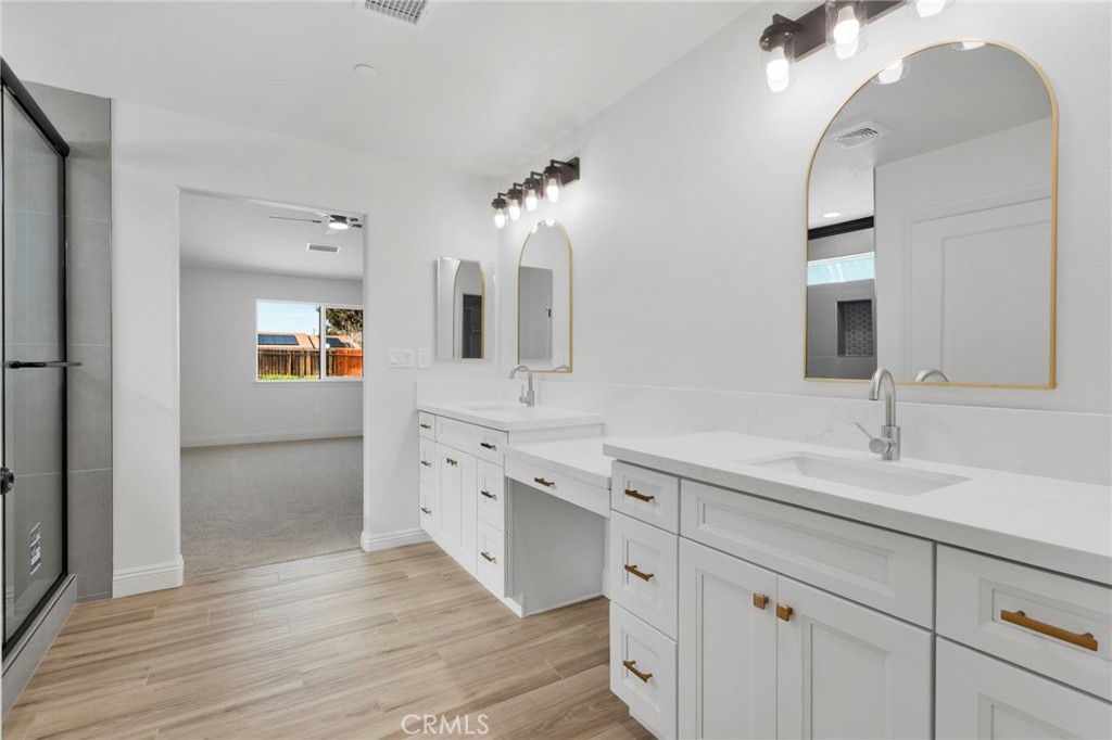9432 Wasco Hesperia, CA 92345 - Photo 28 of 45 a spacious bathroom with double vanity sink and a mirror