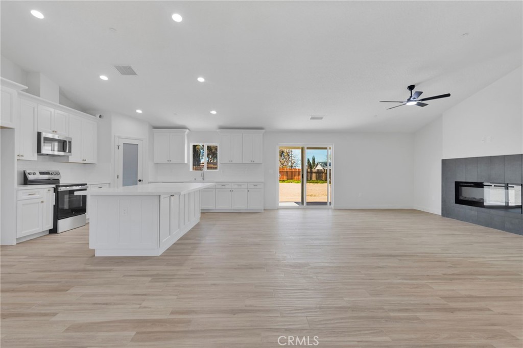 9432 Wasco Hesperia, CA 92345 - Photo 29 of 45 a view of kitchen and empty room with wooden floor