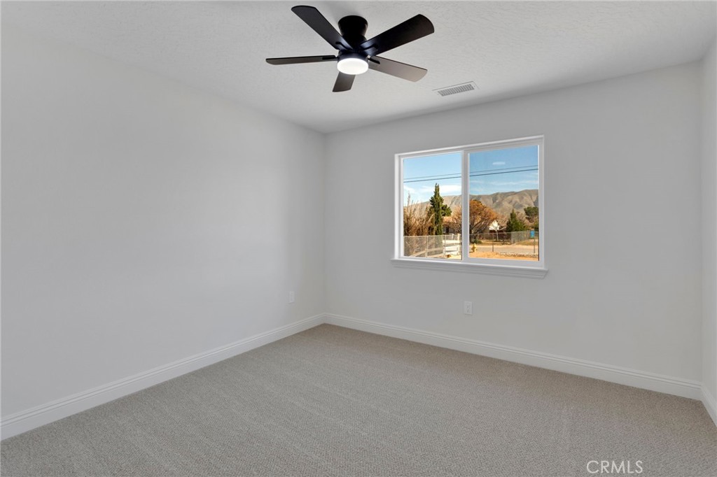 9432 Wasco Hesperia, CA 92345 - Photo 32 of 45 an empty room with a window and a fan