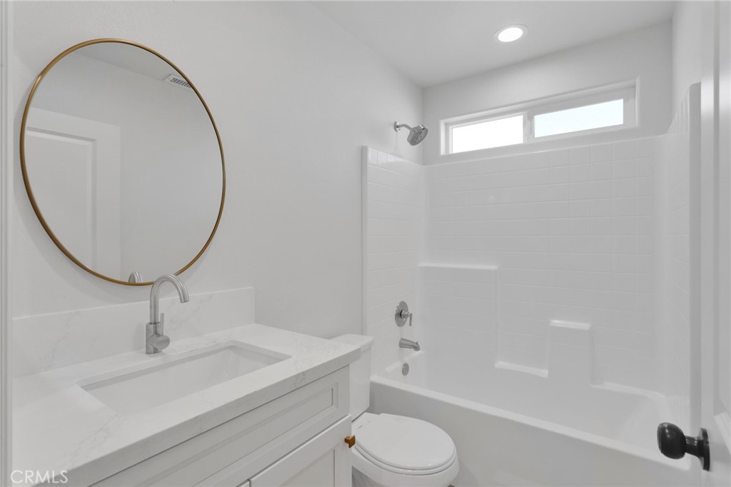 9432 Wasco Hesperia, CA 92345 - Photo 34 of 45 a bathroom with a sink a toilet and a mirror