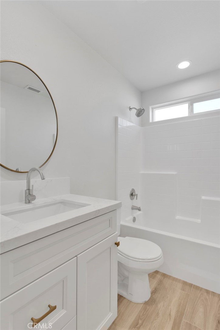 9432 Wasco Hesperia, CA 92345 - Photo 35 of 45 a bathroom with a toilet a sink and a mirror