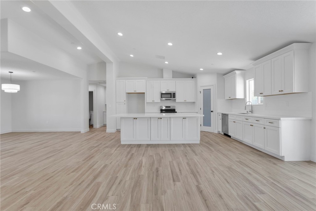 9432 Wasco Hesperia, CA 92345 - Photo 5 of 45 a large kitchen with stainless steel appliances granite countertop a large counter top a sink and a refrigerator