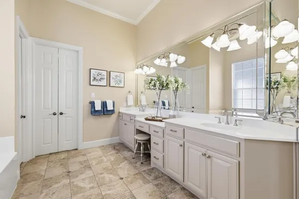 a bathroom with a granite countertop sink a toilet and a large mirror
