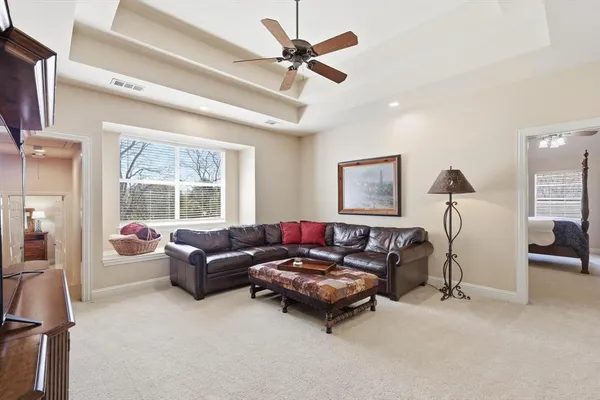 a kitchen with stainless steel appliances granite countertop a stove top oven a sink dishwasher and white cabinets with wooden floor