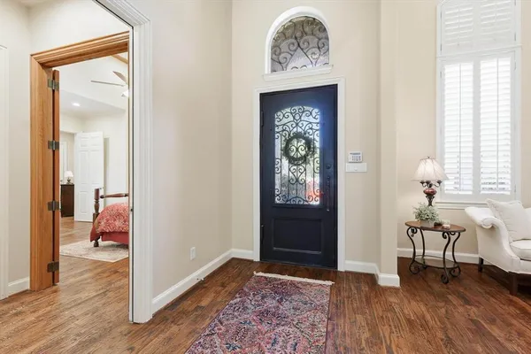 a living room with furniture and a lamp