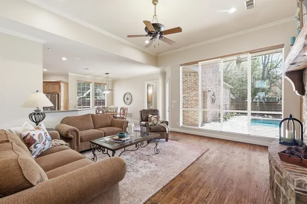 a living room with furniture and a large window with wooden floor