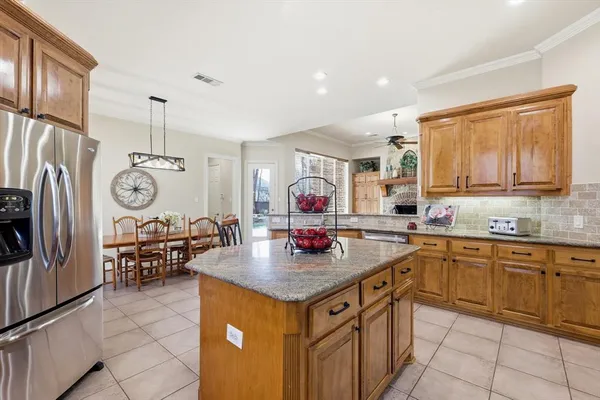 a kitchen with stainless steel appliances granite countertop a stove top oven a sink dishwasher and cabinets with wooden floor