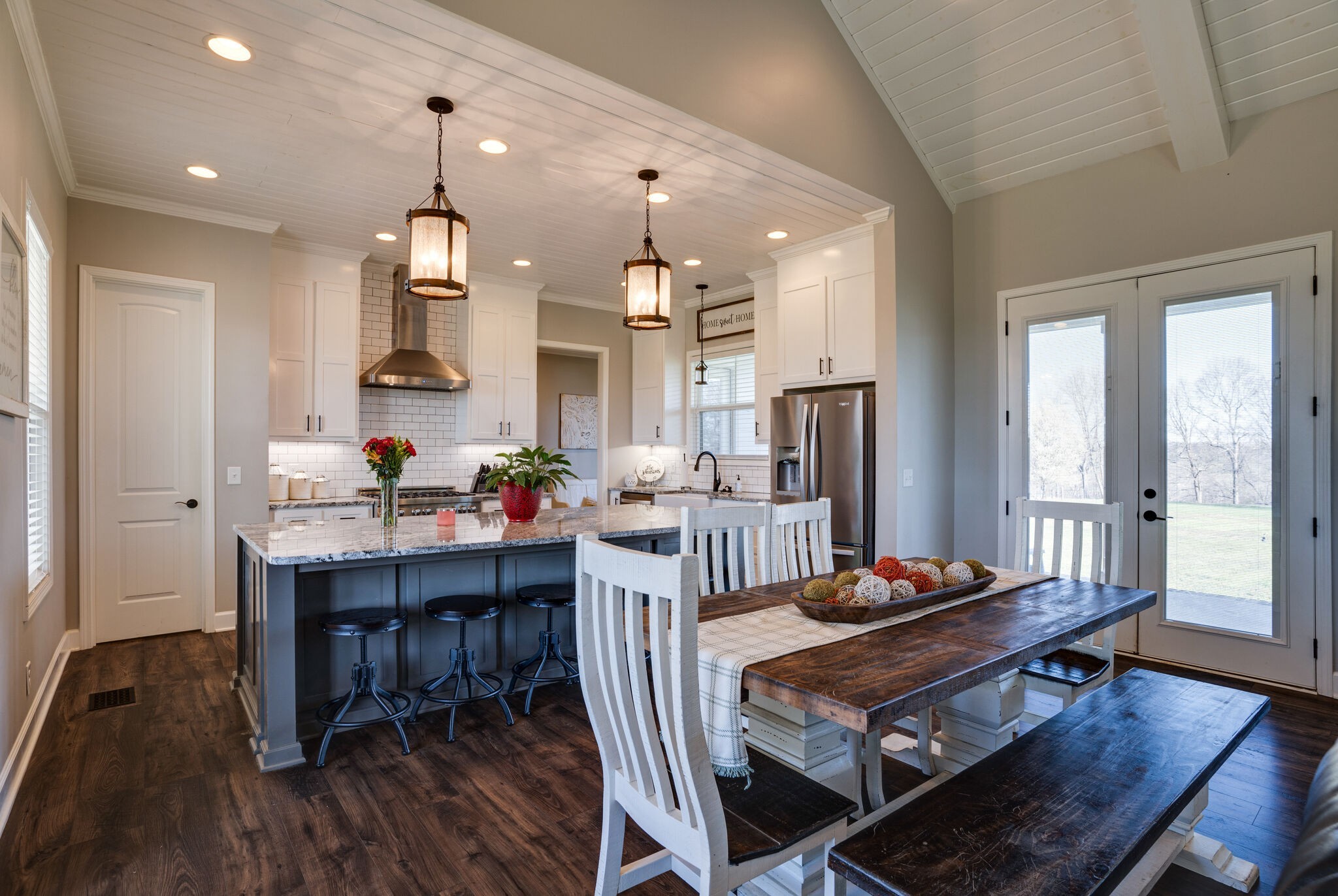 295 Ben Armstrong Road Castalian Springs, TN 37031 - Photo 11 of 44 a living room with kitchen island furniture a dining table wooden floor and a fireplace