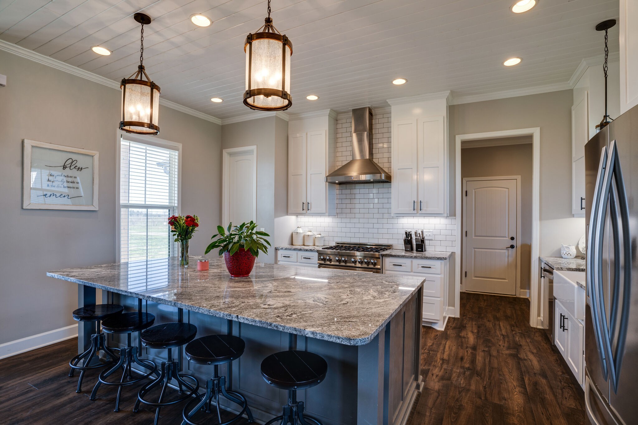 295 Ben Armstrong Road Castalian Springs, TN 37031 - Photo 12 of 44 a kitchen with stainless steel appliances granite countertop a stove refrigerator and wooden floor