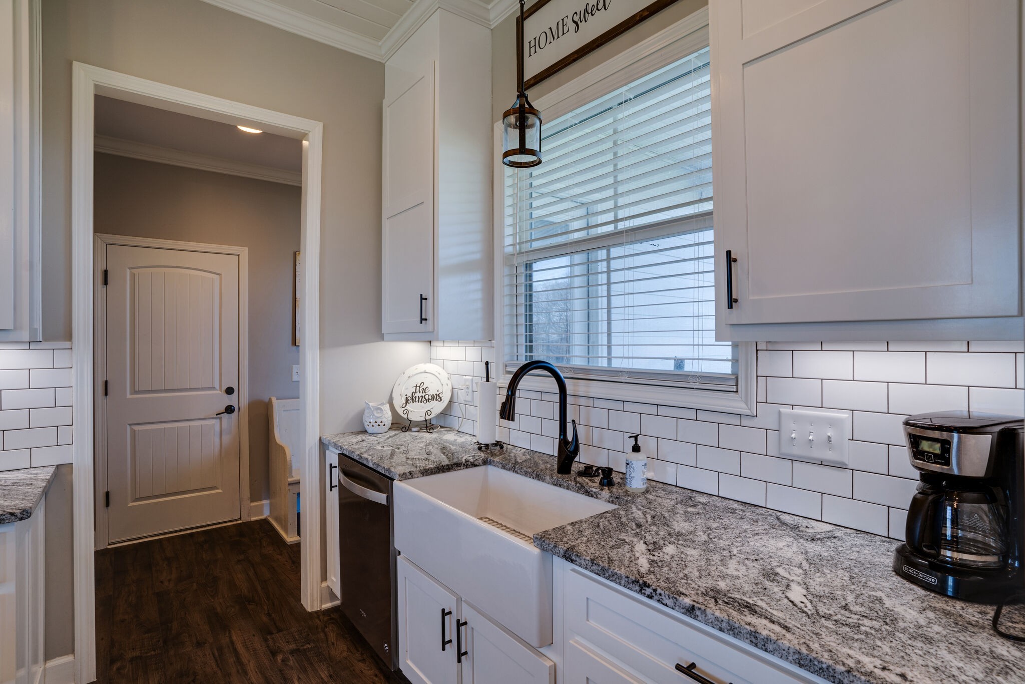295 Ben Armstrong Road Castalian Springs, TN 37031 - Photo 15 of 44 a kitchen with a sink cabinets and wooden floor