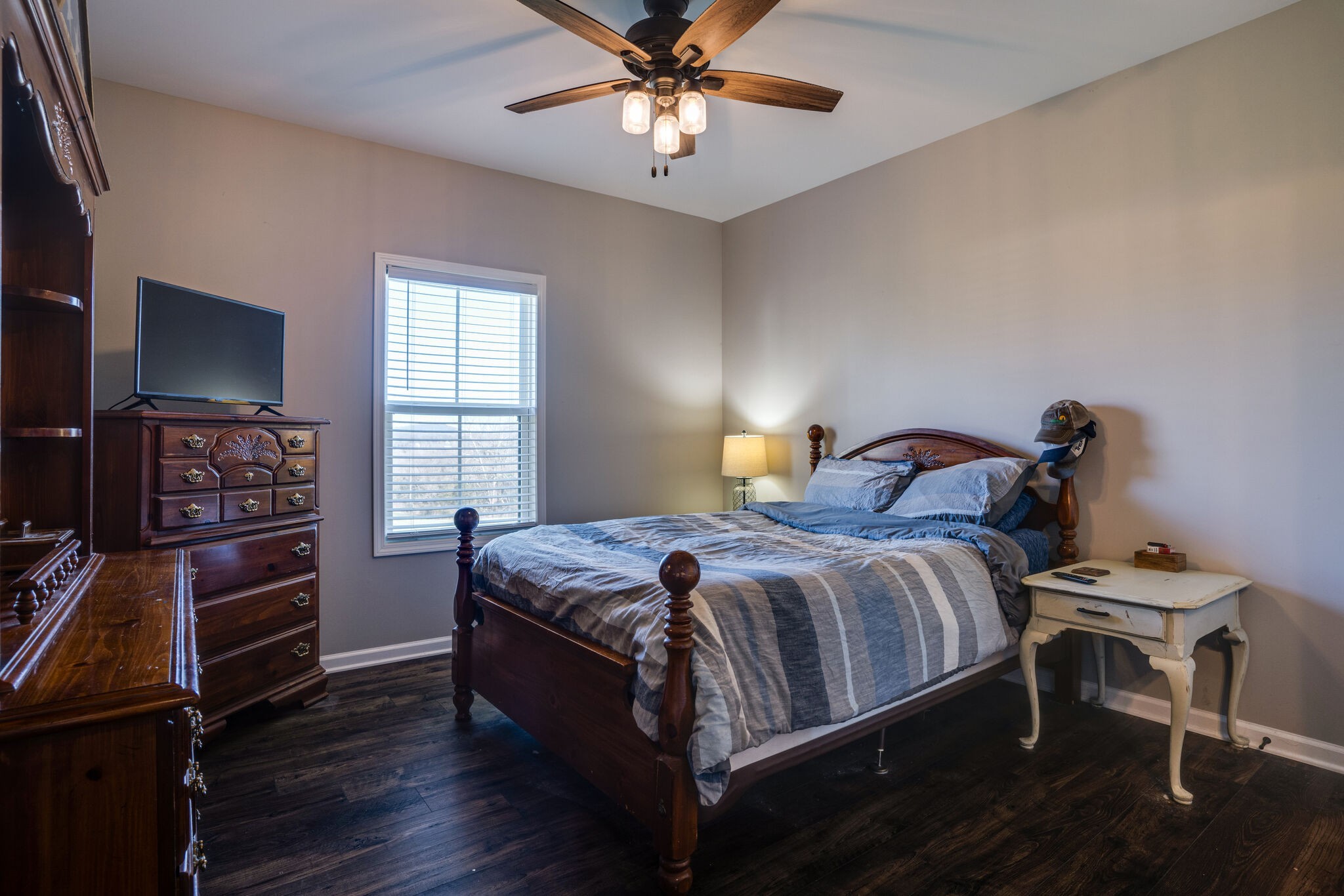 295 Ben Armstrong Road Castalian Springs, TN 37031 - Photo 27 of 44 a bedroom with a bed and a chandelier