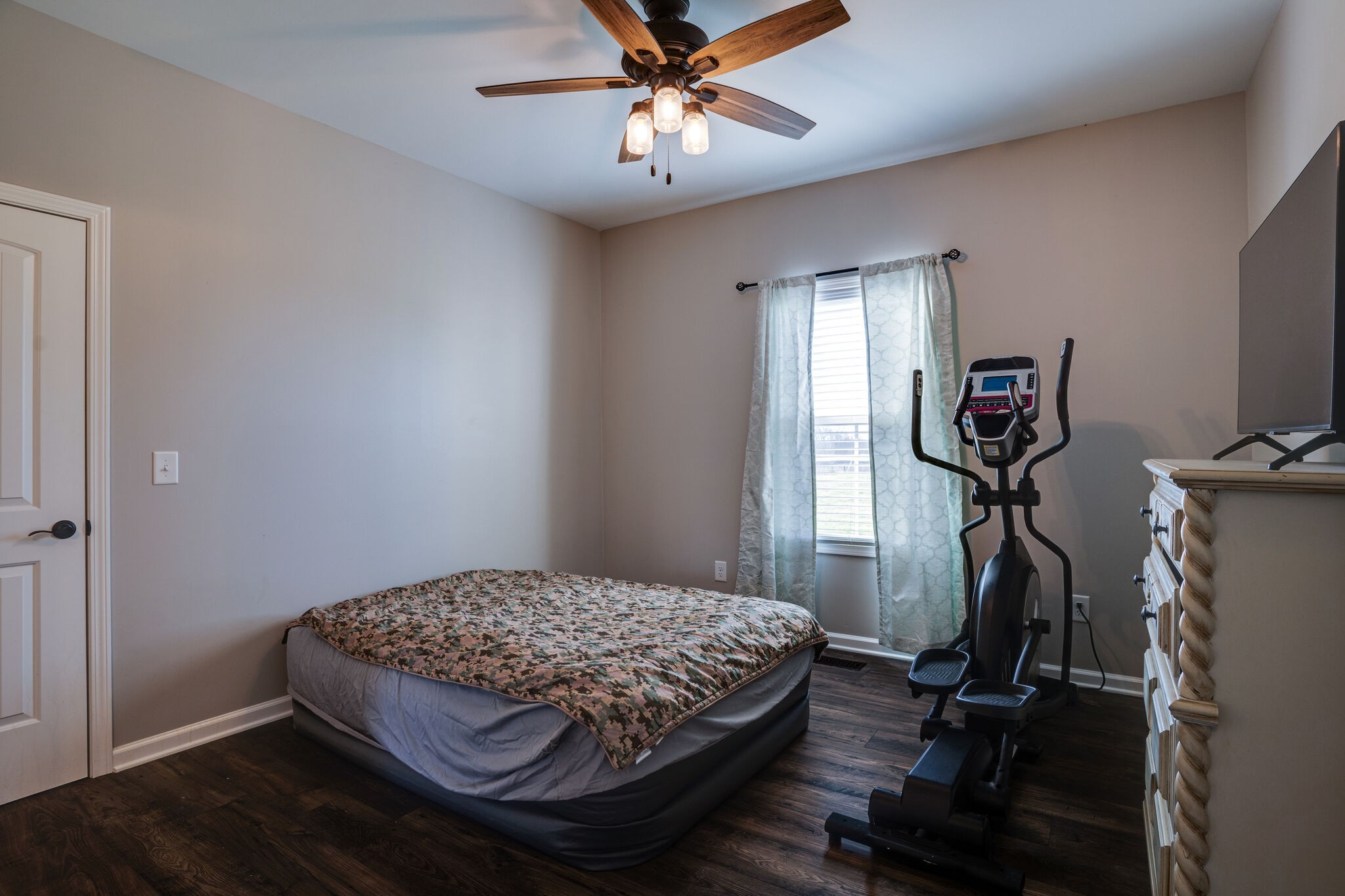 295 Ben Armstrong Road Castalian Springs, TN 37031 - Photo 31 of 44 a bedroom with a bed and a chandelier