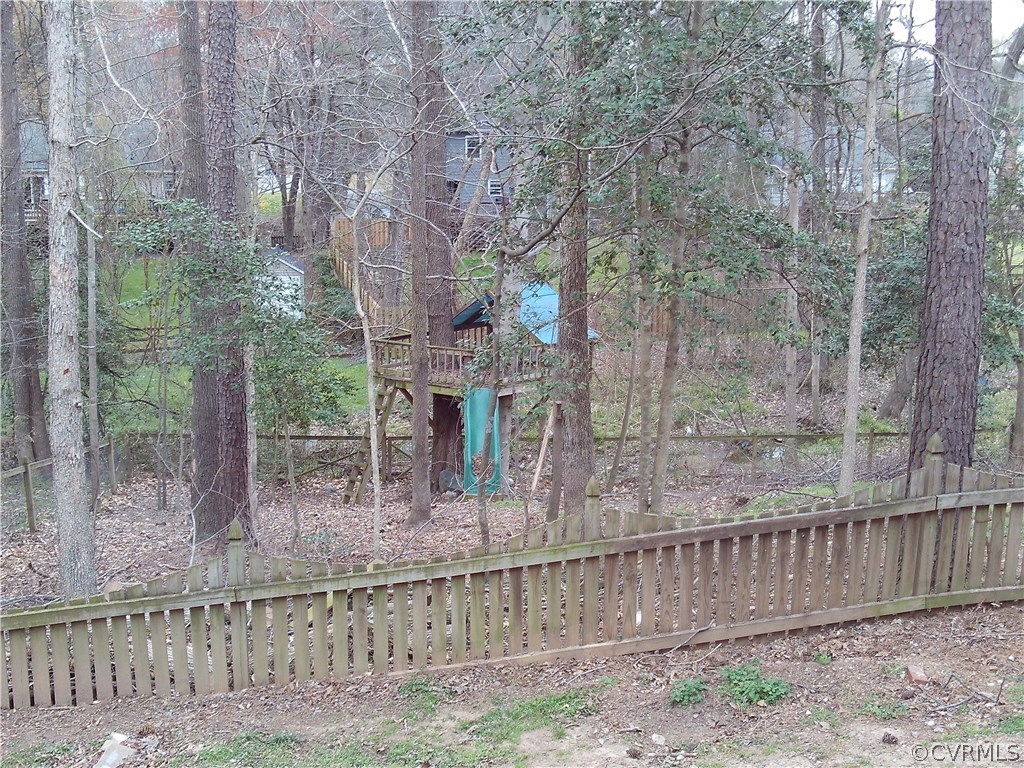 7029 Pointer Ridge Road Midlothian, VA 23112 - Photo 27 of 27 a backyard of a house with lots of green space and glass windows