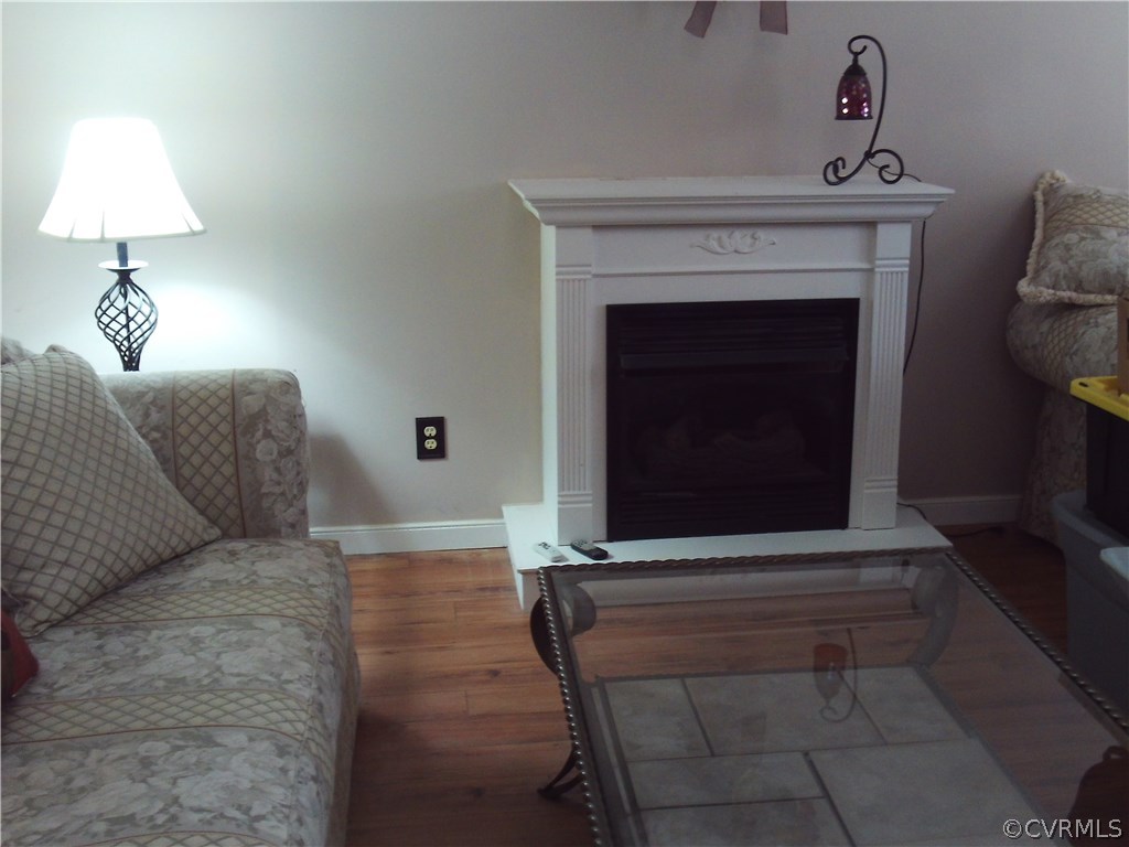 7029 Pointer Ridge Road Midlothian, VA 23112 - Photo 7 of 27 a living room with furniture and a fireplace