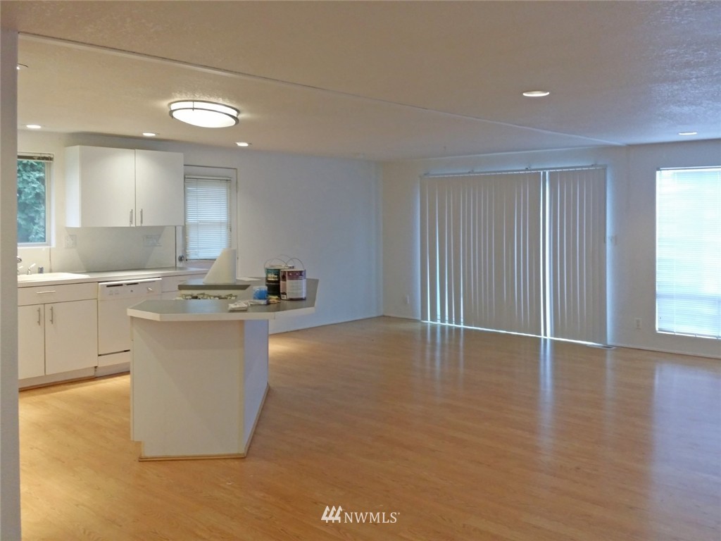 19007 126th Avenue Northeast Bothell, WA 98011 - Photo 4 of 15 a room with kitchen island a sink a stove a counter space and a window