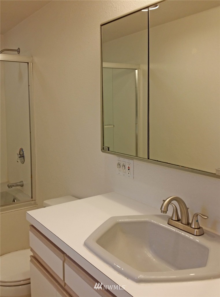 19007 126th Avenue Northeast Bothell, WA 98011 - Photo 9 of 15 a bathroom with a sink and a mirror