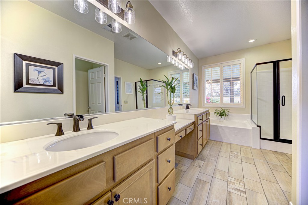 32185 Bandelier Road Winchester, CA 92596 - Photo 16 of 47 a bathroom with a granite countertop sink mirror and a bathtub