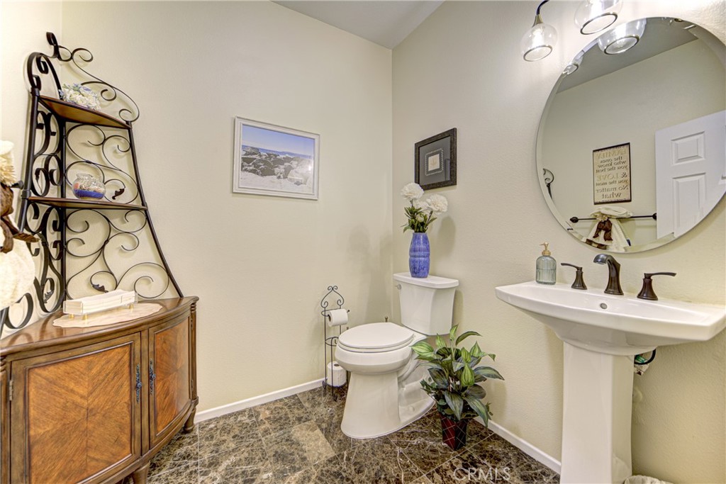 32185 Bandelier Road Winchester, CA 92596 - Photo 23 of 47 a bathroom with a sink mirror and toilet