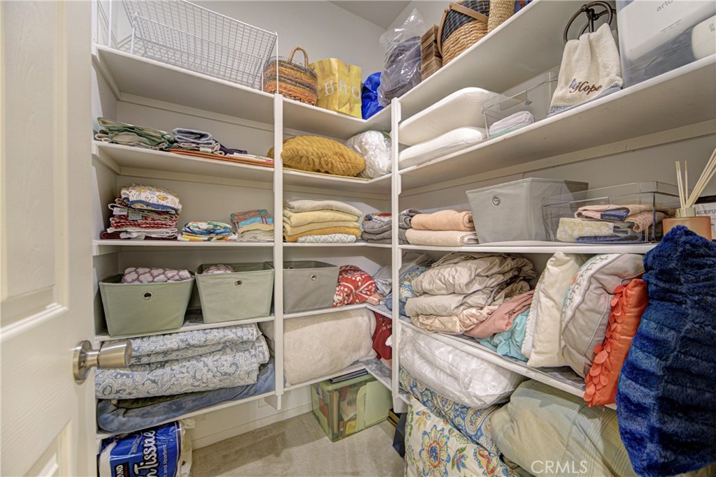 32185 Bandelier Road Winchester, CA 92596 - Photo 25 of 47 a view of walk in closet with clothes and shoes