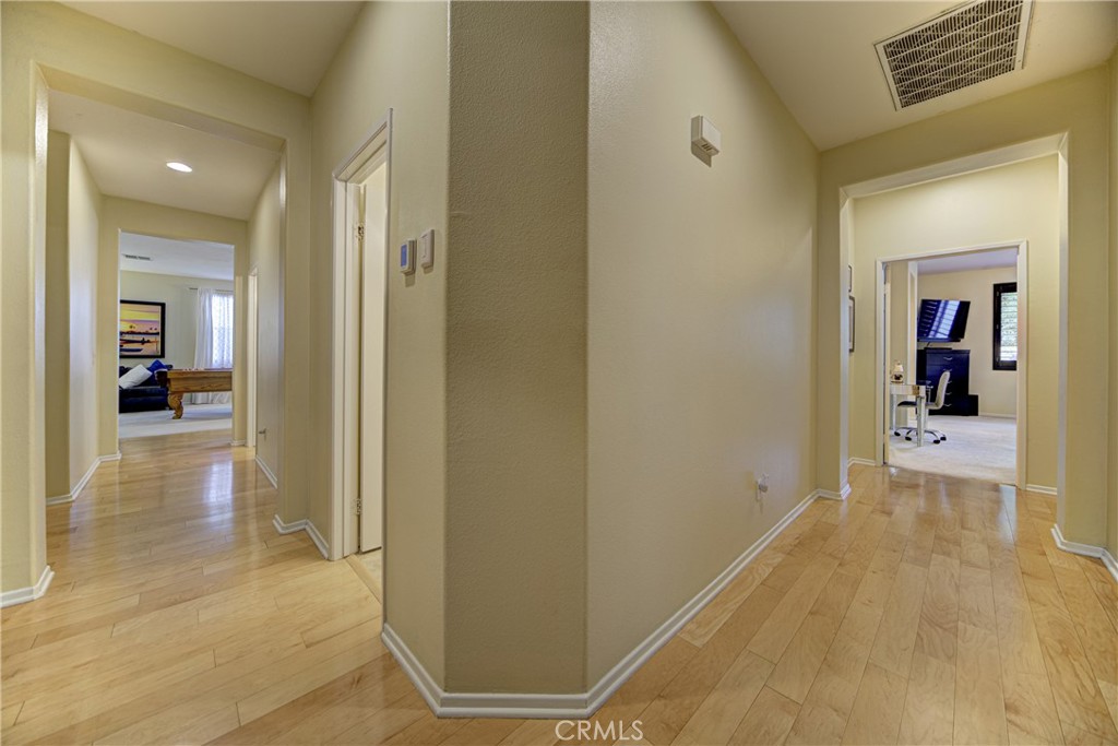 32185 Bandelier Road Winchester, CA 92596 - Photo 27 of 47 a view of a hallway with wooden floor and a living room