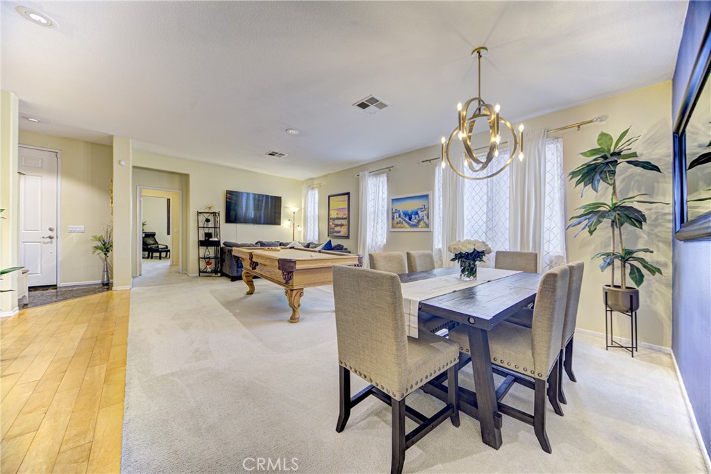 32185 Bandelier Road Winchester, CA 92596 - Photo 3 of 47 a view of a dining room with furniture and chandelier