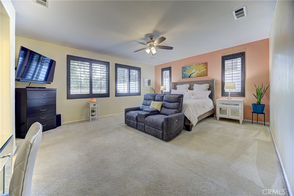32185 Bandelier Road Winchester, CA 92596 - Photo 5 of 47 a spacious bedroom with a bed and a couch