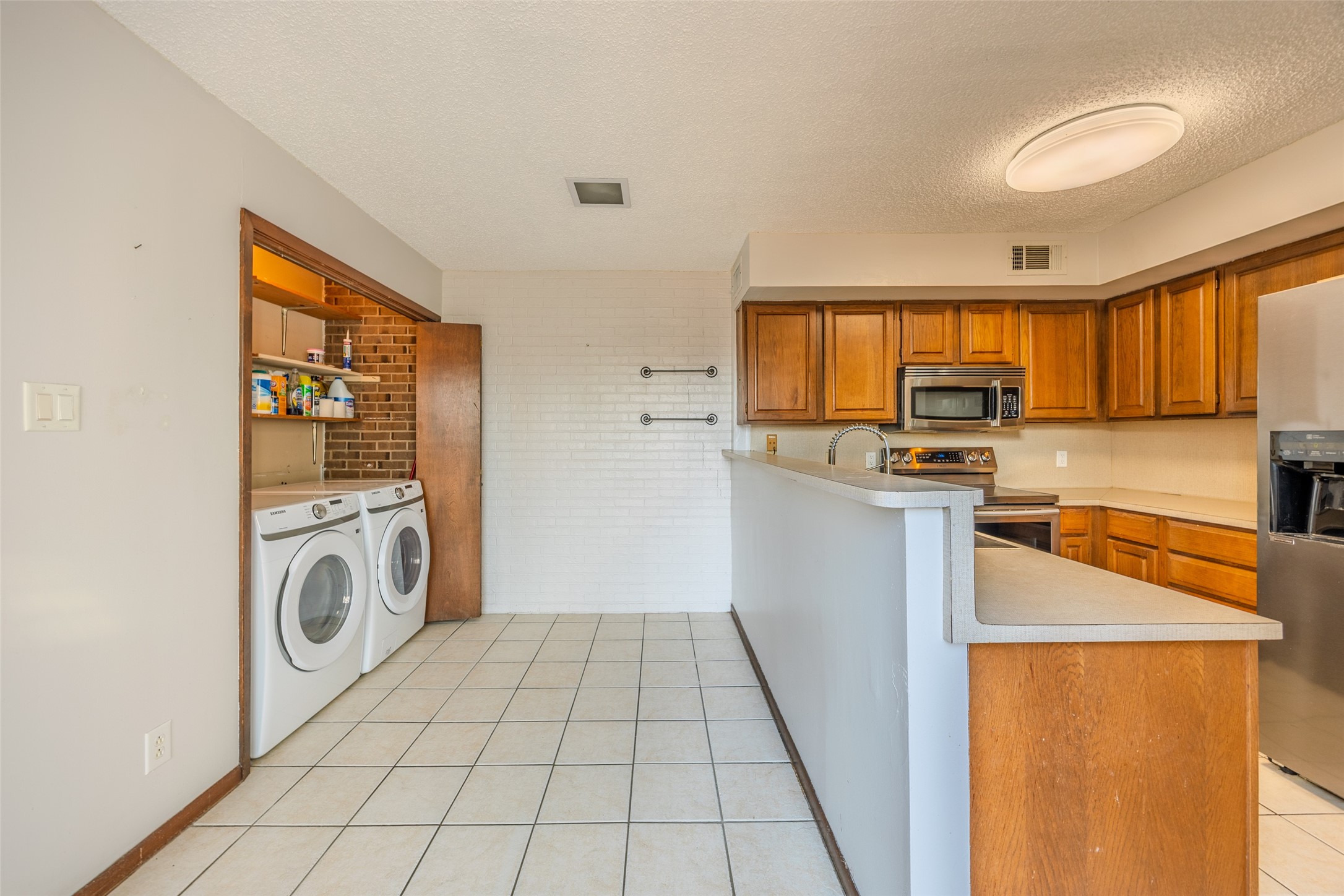 2002 South Lubbock Street Brenham, TX 77833 - Photo 14 of 26 a view of a kitchen with a sink refrigerator and window