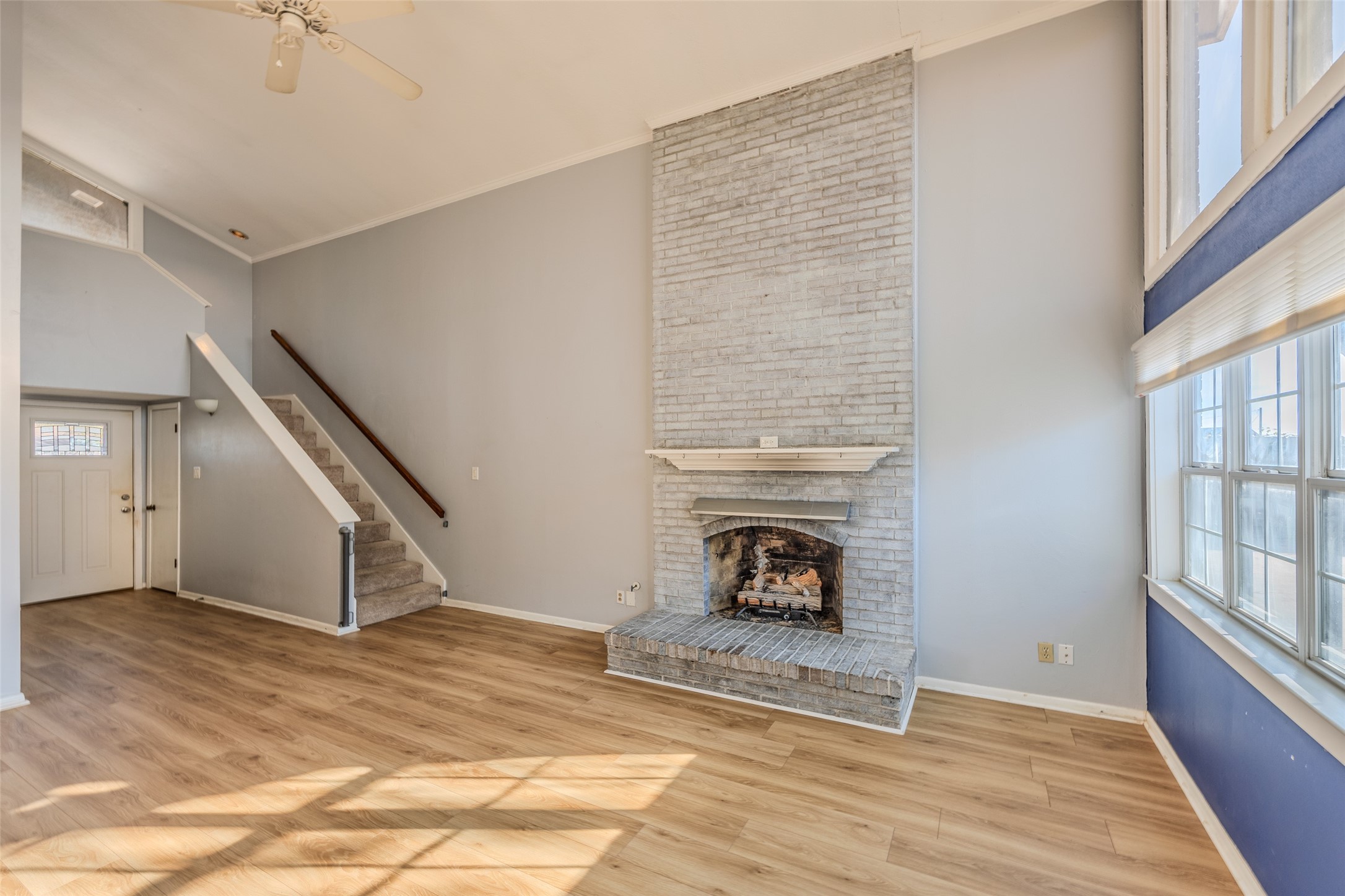2002 South Lubbock Street Brenham, TX 77833 - Photo 7 of 26 a view of an empty room with wooden floor fireplace and a window