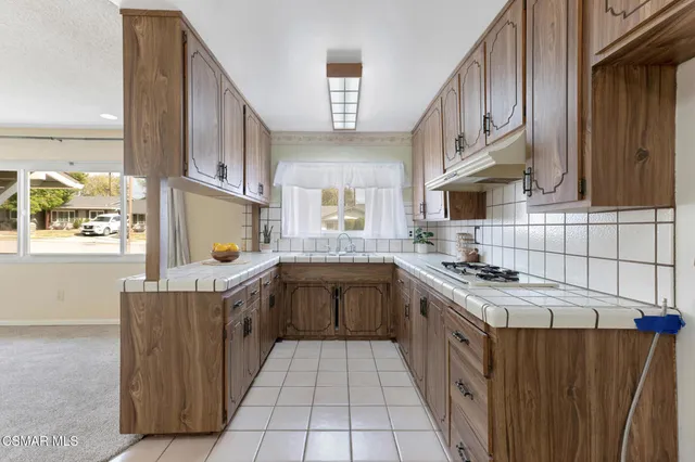 a kitchen with a sink cabinets and window