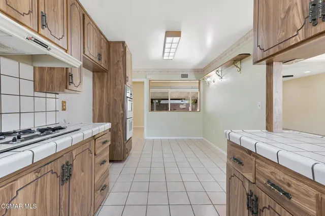 a view of an empty room with a fireplace and a window