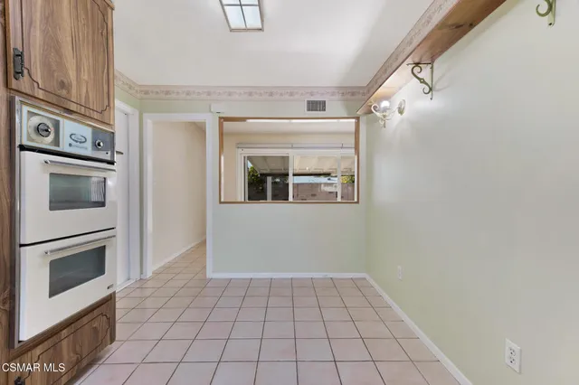a kitchen with a sink a counter top space and cabinets